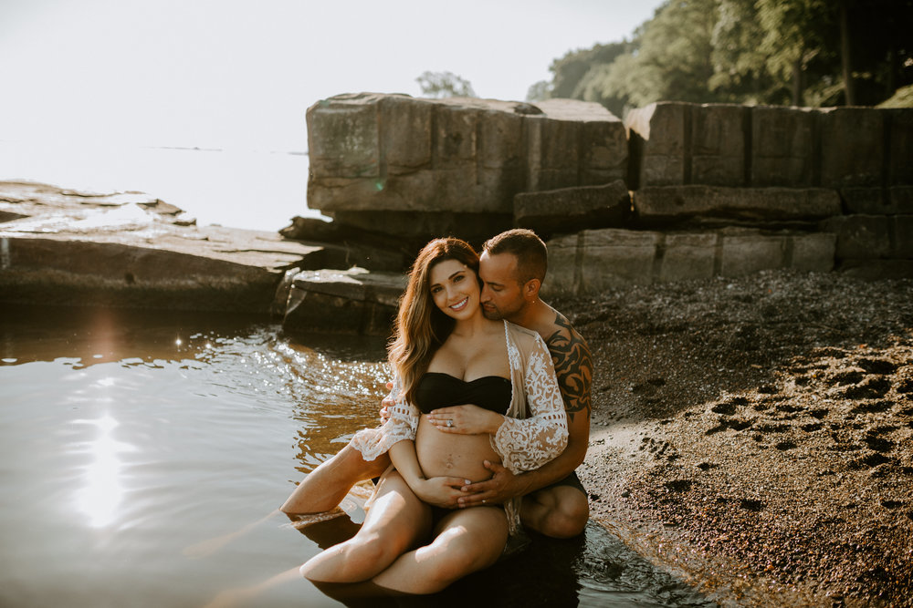 husband and wife maternity photos at the beach